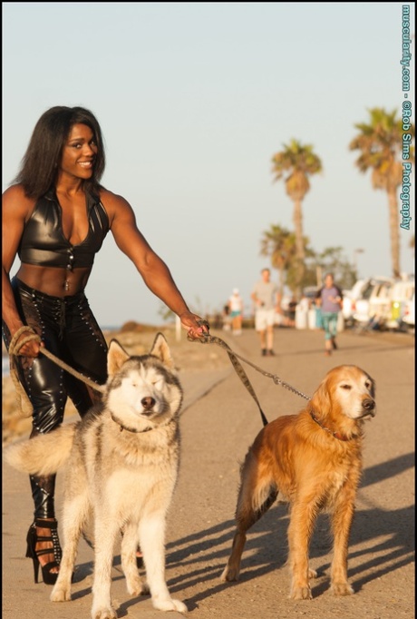 Black bodybuilder Jaquita Persons Taylor flexes while walking her dogs 48119249