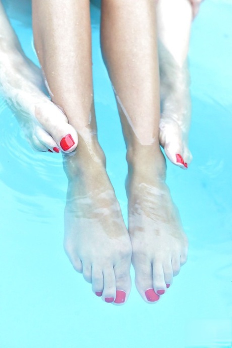 Leggy lesbians Danielle Maye and Loulou Petite suck toes in swimming pool 83138153